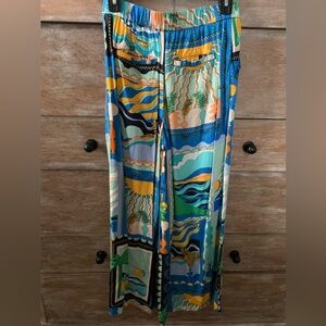 Maeve Anthropologie wide flare leg pants in blue-orange tropical pattern.